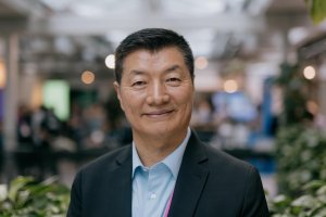 Headshot of Lobsang Sangay. He has short black hair and is wearing a black suit jacket and blue shirt.