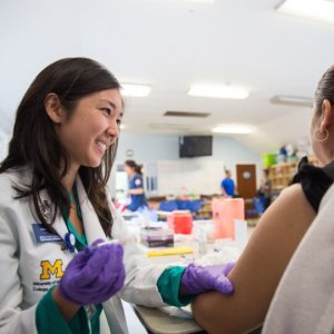 College of Pharmacy student administering a vaccine shot in a clinical setting