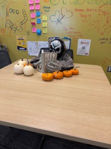 Image of plastic skeleton at a table holding a book.