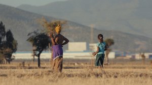 Farmer Workinesh Chala and her daughter Rehoboth standing in the fields of Dibdibbe Village, looking out towards the Eastern Industry Park, Oromia region, Ethiopia. Photo credit: Max Duncan. Courtesy of Hard Truth Films.