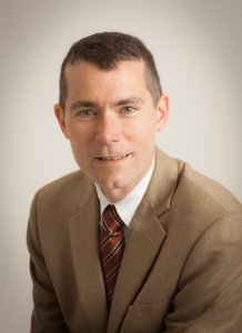 a portrait photo of the speaker