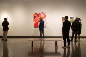 Gallery visitors view work at the 2024 Undergraduate Juried Exhibition.