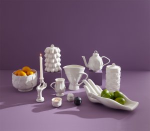 Image of white ceramic vessels on purple background