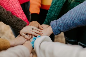 group with hands piled together