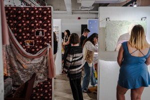 Visitors view student work installed in studios at the 2025 IP Exhibition