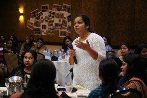 A woman advises the CEO, (out of frame), while he fields questions from the floor, A Celebration of Woman’s Day, Seattle Region, Bellevue, Washington, USA. All the women shown work in high tech as consultants in the US. They are the best and brightest from universities in India. They remain concerned about children in general but specifically girls in India and the rest of the developing world and aspire to help them. A sub-section of technology workers, many of these women are in the US on H1-B Visas.drop a penny if you wish https://paypal.me/1drlanewonderlane@gmail.com