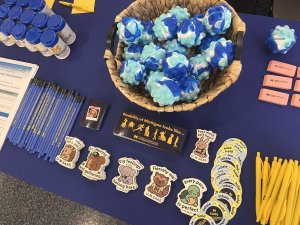 Services for Students with Disabilities event tabling set-up featuring stress balls and cute animal stickers.