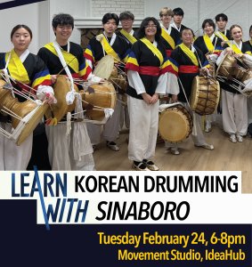 Twelve students pose with drums in traditional Korean costume