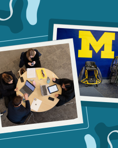 A group of students working around a table set atop of a photo of wheelchairs with a block M background.