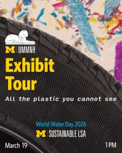 A close up of a car tire with colorful plastic sprinkled behind