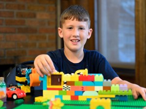 A Family Day participant builds with LEGO blocks.