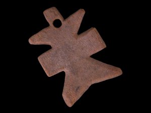 Piece of wood carved into the shape of a cross with a borehole near its top.
