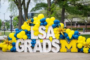 Photo station with "LSA Grads" marquee letters and balloons