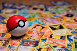 Classic Pokeball Toy on a bunch of Pokemon Cards. Zapdos, Ninetales and a Trainercard visible.