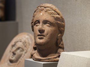 Clay head of a woman on display in the Kelsey Museum’s Roman collection.