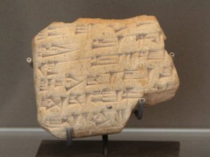 A tablet of Zimri Lim, a roughly rectangular clay tablet with Akkadian inscriptions.