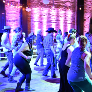 People line dancing at the Ypsilanti Freighthouse