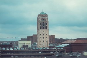 U-M Central Campus building rooftops surround Burton Tower on a cloudy day.