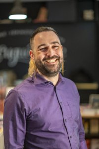 Photograph of Chacha Enriquez smiling in a purple shirt.