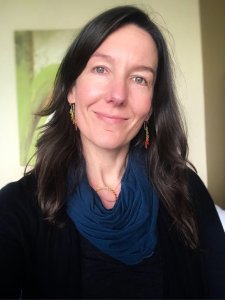 Image of individual with black shirt and blue scarf