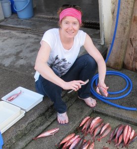 Amanda Ackiss in the field posing with fish specimen