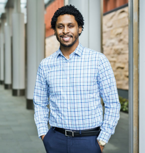 Headshot of Tristan Layfield, University of Michigan alumnus and career coach, smiling at the camera. He will present an alumni career webinar on LinkedIn strategy, covering how the platform works today, what recruiters see, and how to increase visibility with decision-makers.