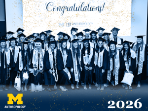 U-M Anthropology graduating class poses together in caps and gowns at their graduation ceremony.