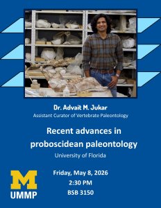 Dr. Advait Jukar standing in front of a museum's collections of fossils