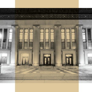 Lit columns and grand steps create a classic, welcoming entry to Hill Auditorium at night.