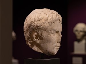 Profile view of the marble head of the Roman emperor Augustus on display at the Kelsey Museum.