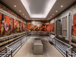 Panoramic view of the Kelsey Museum’s Villa of the Mysteries room, featuring colorful watercolor fresco reproductions displaying the steps of a Dionysian cult ritual.