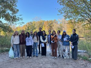 Students from the 2025 International Center Nature Walk smile at the camera while standing on a trail.