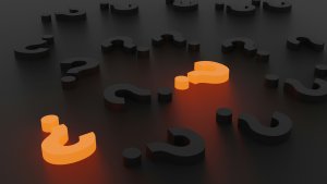 Question marks against a dark background