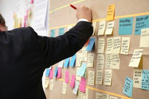 Person looks at sticky notes
