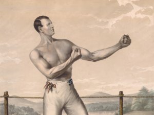 A 19th-century lithograph of American bare-knuckle boxer Tom Hyer. He stands shirtless in the ring with his fists upraised.