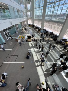 Students gather for a demo day in the Robotics Building atrium with robotics projects on display