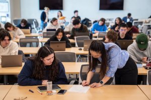 Professor teaching a large lecture hall of students at U-M.