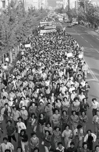 Captured by journalist Na Kyung-taek in May 1980, this image shows Chonnam National University students marching in Gwangju, South Korea, shortly before the May 18 Democratization Movement.