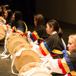 Group of people performing traditional Korean drumming