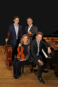 The Berofsky Quartet poses with piano and string instruments.