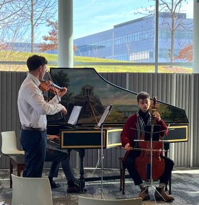 Musicians perform on harpsichord and string instruments at the North Campus Research Complex.