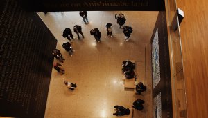 A birdseye view of a small group of people looking around a gallery