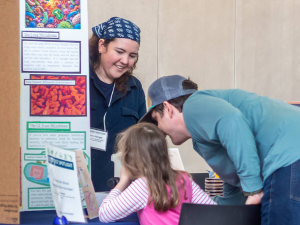 Scientist presents work to father and daughter