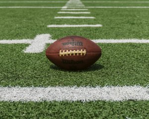 Football laying on a football field