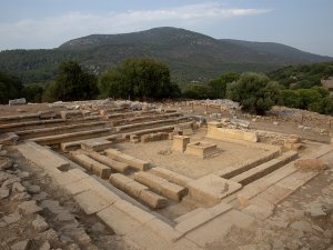 View of the remains of the Bouleuterion (Council House) at Notion, Türkiye, with theater-like seating surrounding a central podium.
