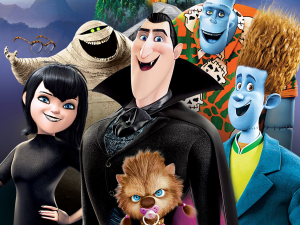 Six animated monster characters pose together, including a vampire, a mummy, a werewolf baby, two smiling blue men, and a girl with black hair, all displaying playful and friendly expressions.