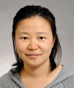 Female-presenting person smiles at the camera
