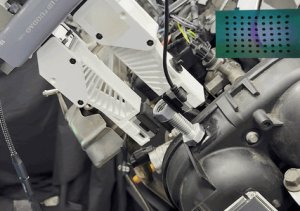 Robotic end effector places hex nut onto bolt.