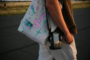 Person with tote bag and camera.