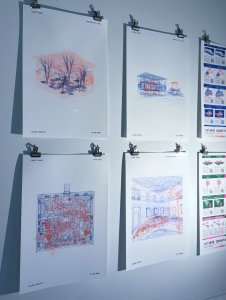 Pen-drawn architecture sketches hung on a white wall.